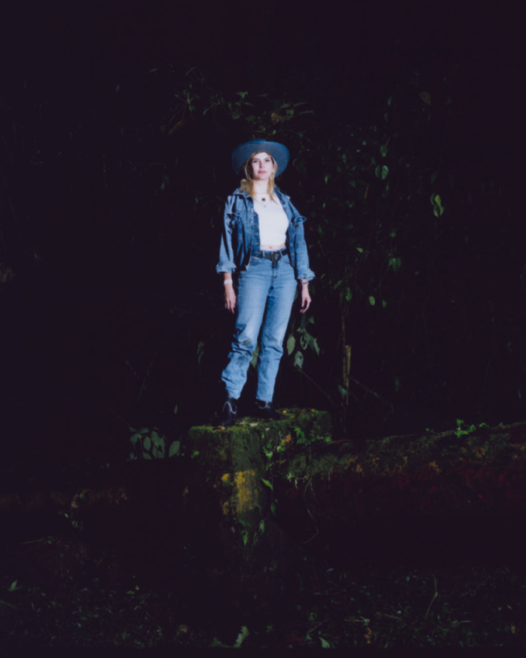 Gissell Garrido in full denim on denim standing in a forrest